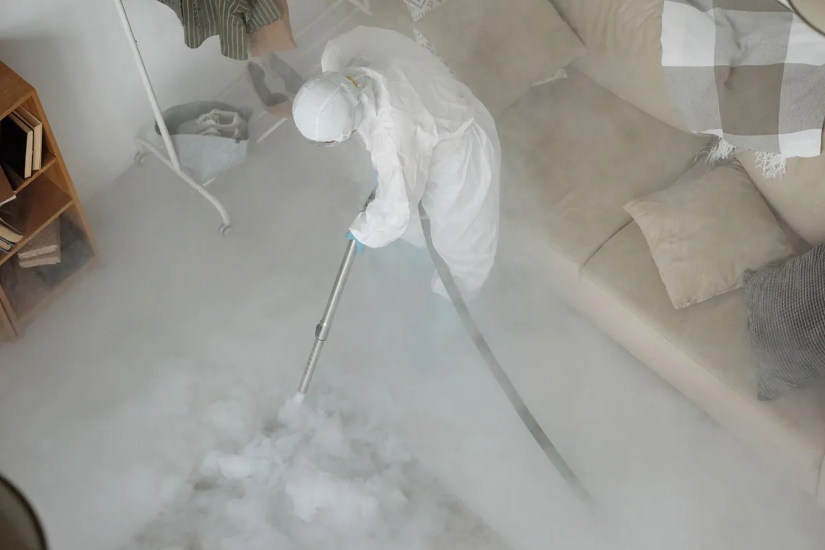 Biohazard cleanup technician in protective equipment, Mount Sinai, NY